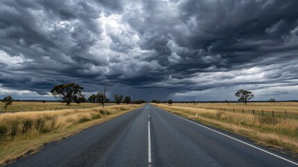 Matilda Highway's endless straight path beneath a dramatic cloudy sky in Queensland
