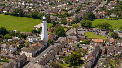 Aerial Withernsea UK.Withernsea  is a seaside resort town and civil parish in Holderness, East Riding of Yorkshire, England. Its white inland lighthouse, rising around 127 feet (39 m) 