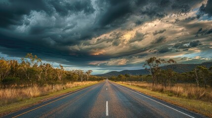 Fototapeta premium Scenic view of the straight path of Matilda Highway under a moody cloudy sky in Queensland
