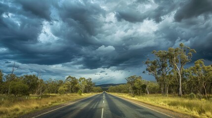 Fototapeta premium Scenic view of the straight path of Matilda Highway under a moody cloudy sky in Queensland