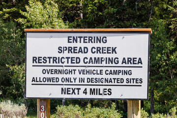 Spread Creek dispersed camping sign in Bridger-Teton National Forest, Jackson Hole, Wyoming during summer.