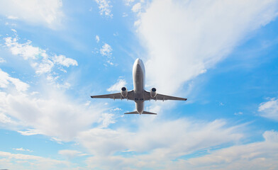 White passenger airplane flying in the sky amazing clouds in the background - Travel by air transport