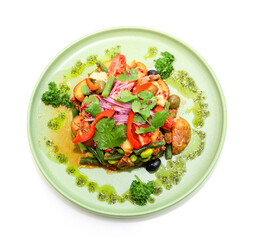 Appetizing salad on a green plate