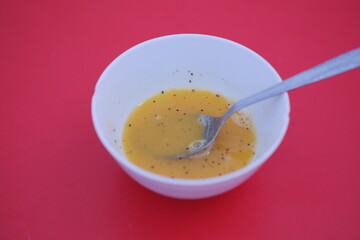 bowl with stirred raw eggs as a background