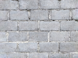 A close-up of a cinder block wall reveals the rugged texture and sturdy construction of each block, interlocked perfectly to form a strong, enduring structure.