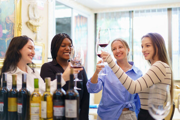 Diverse people are testing wine and talking together in the restaurant.