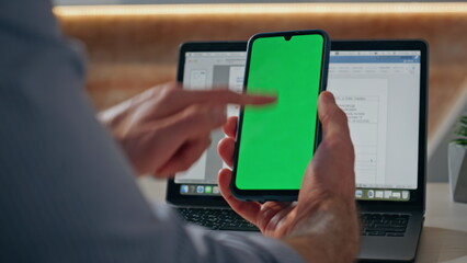 Startuper finger swiping mockup smartphone at table closeup. Man hand browsing