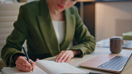 Woman hands writing notes at notebook indoors closeup. Businesswoman reading