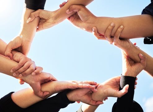 Below, team and hands in circle for support, strength and unity for synergy. Group, huddle or people connected for power, solidarity or trust in community for protest, empowerment or organization