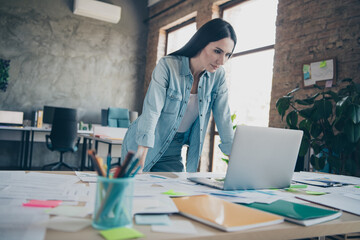 Photo of attractive young woman work graph computer dressed denim clothes executive business leader work comfort beautiful office interior