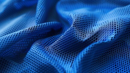 A detailed shot of blue mesh fabric with interesting shadows and light effects creating a dynamic and textured look, highlighting the abstract beauty of the material.