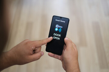'Open door' message on the smartphone screen. Smart home and technology concept.
