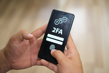 2FA authentication on a mobile screen. Office image in the background. Close-up 