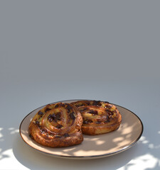 Glass cup of coffee and puff pastry outdoor on table in shade