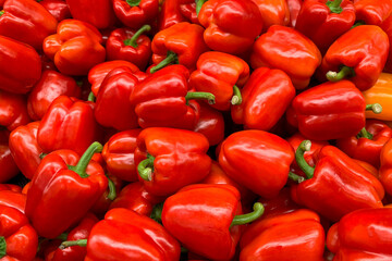 a pile of fresh red bell peppers