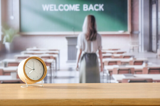 Wooden desk with copy space with blurred school classroom background. Copy space for products. Educational concept. - Powered by Adobe