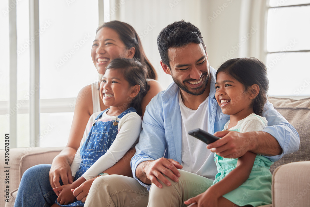 Wall mural Parents, girl and children for watching tv on sofa with remote, hug and happy for show in family home. Father, mother and daughter kids with streaming, subscription and relax with movie in Indonesia