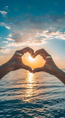 Heart-shaped hands on a background of sea and sky.