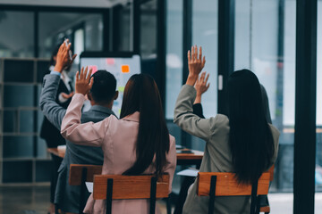 Group of young Asian business people brainstorm collaboration ideas at the office.
