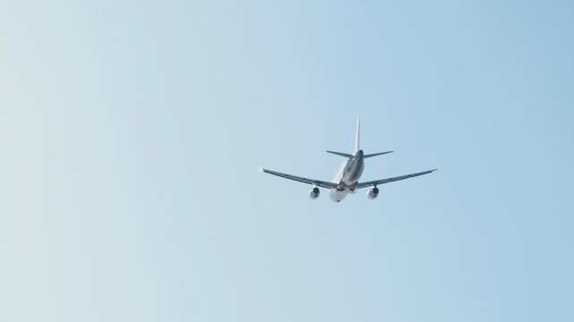 Jet airplane takes off, bottom view. Airplane in the sky, landing gear retracting