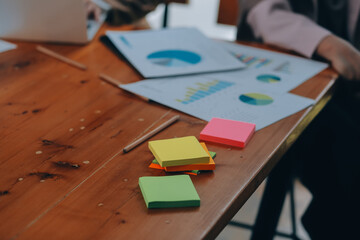 Group of young Asian business people brainstorm collaboration ideas at the office.