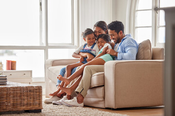 Family, couch and hug in home living room for support, relax and unity with parents in lounge....