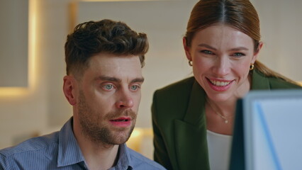 Two coworkers looking computer monitor creating project together close up. 