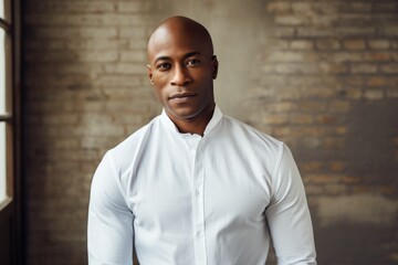 Obraz premium Portrait of a content afro-american man in his 40s wearing a classic white shirt in scandinavian-style interior background