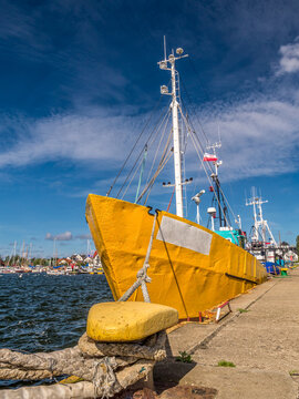 Yellow cutter berthed to the bollar at the harbour