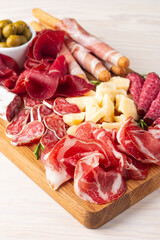 Charcuterie board. Antipasti appetizers of meat and cheese platter with salami, prosciutto crudo or...