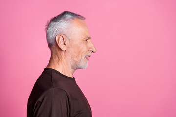 Side profile of nice man with white gray beard dressed brown t-shirt look at discount empty space isolated on pink color background