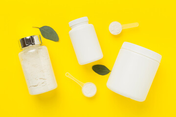 Jars with protein powder on color background, top view. Sports nutrition concept