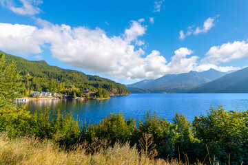 Naklejka premium Kootenay Lake, Kaslo Bay and mountains in the rural village of Kaslo, British Columbia, Canada at early summer. 