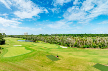 Fototapeta premium Drone view of golf course with forest