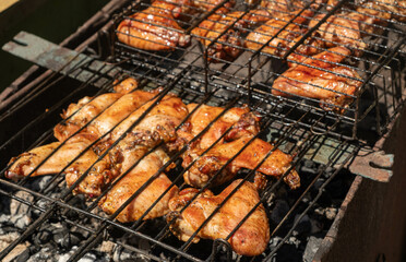 Close up Juicy Grilled Chicken on the BBQ on coals.