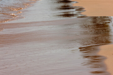 The Lake Michigan waves receding off the smooth beach sand at Harrington Beach State Park, Belgium, Wisconsin in mid-September