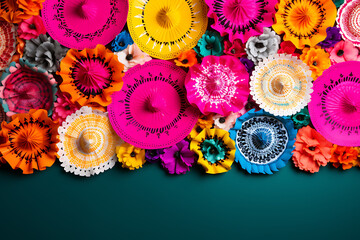 Colorful handmade paper flowers of various sizes on a dark green background