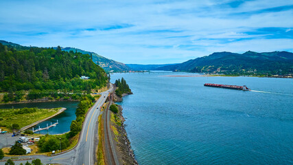 Naklejka premium Aerial View of Columbia Gorge River with Barge and Highway