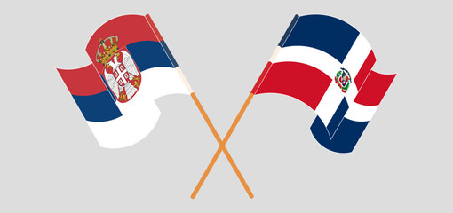 Crossed and waving flags of Serbia and Dominican Republic
