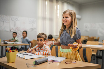 young caucasian girl stand and answer question of teacher