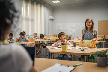 young caucasian girl stand and answer question of teacher