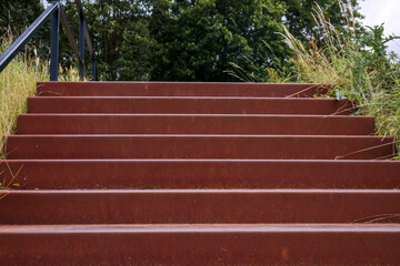 Iron dark red staircase, play of lines, lines, abstract, geometric, iron, hardware, upwards, climbing, going up, railing.