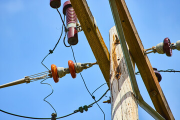 Utility Pole with Insulators and Power Lines from Below