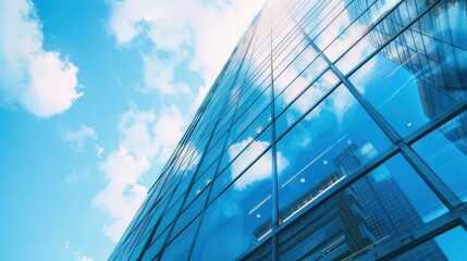 A tall building with a lot of windows and a cloudy sky in the background
