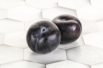 Two ripe sweet black plums