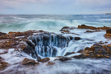 Thor's Well Cascade and Rugged Rocky Shoreline at Eye Level