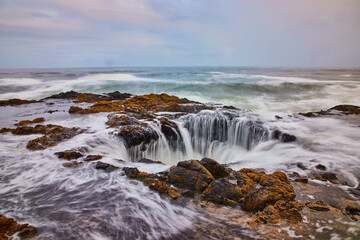 Ocean Waterfall Over Rocks at Thor's Well Oregon - Aerial View