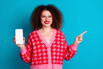 Photo of adorable lovely girl wear red cardigan eyeglasses showing modern device pointing empty...