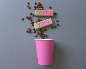 Thank you symbol. Wooden blocks with words Thank you. Beautiful grey background with coffee cup. Business and Thank you concept. Copy space.