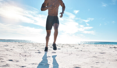 Man, fitness and running on beach for exercise, workout and cardiovascular health outdoor. Athlete, jog and high intensity training by ocean with sand, sun and water for speed and performance